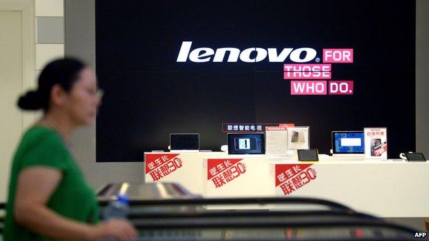 A woman walks by a Lenovo shop in China