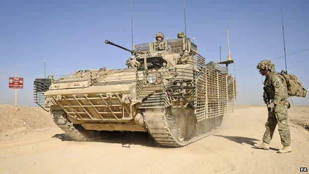 A Warrior tracked armoured vehicle and soldier