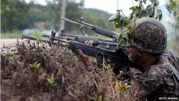 In this handout provided by the Hong Jin-Hwan-Donga Daily, South Korean soldiers patrol as they search for a soldier who is on the run after a shooting on 22 June 2014 in Goseong-gun, South Korea.