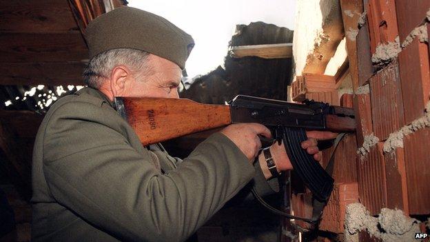 A Serb fighter fires his machine gun at a Croatian force (1993)