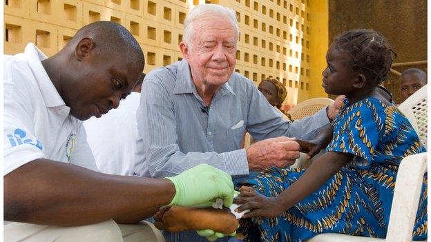 Former US president Jimmy Carter with young Guinea worm patient