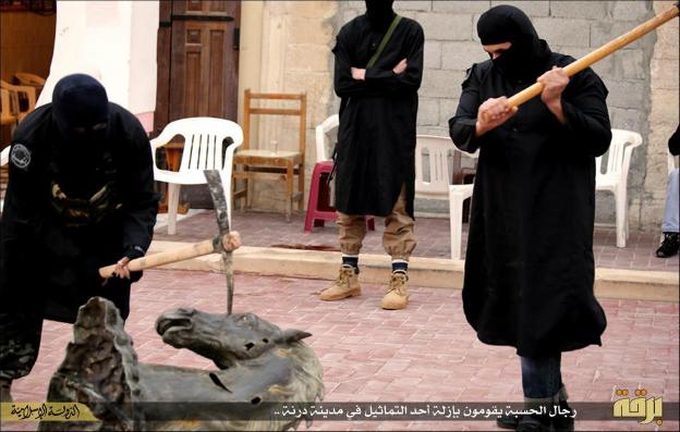 An image posted online by militants who claim to be part of the Islamic State group showing them destroying statues in Derna - 1 February 2015