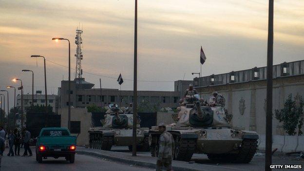 Egyptian security forces deployed outside the police institute near Cairo's Turah prison during the trial of detained al-Jazeera journalists