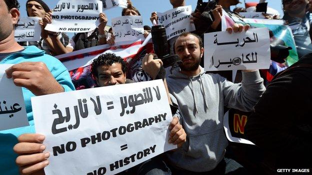 People protest against laws restricting reporters