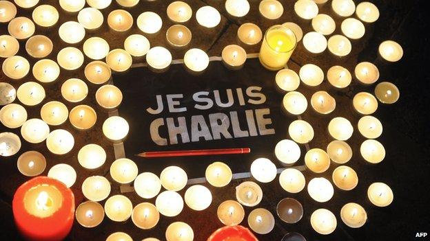 Je Suis Charlie message surrounded by candles