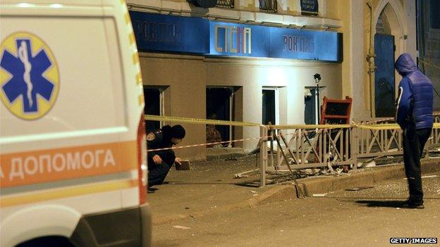 Police experts search for evidence after an explosion in a pub