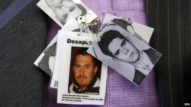 A member of an NGO wears pictures of disappeared people in Mexico during the meeting of the United Nation Committee on Enforced Disappearances in Geneva on 2 February, 2015.