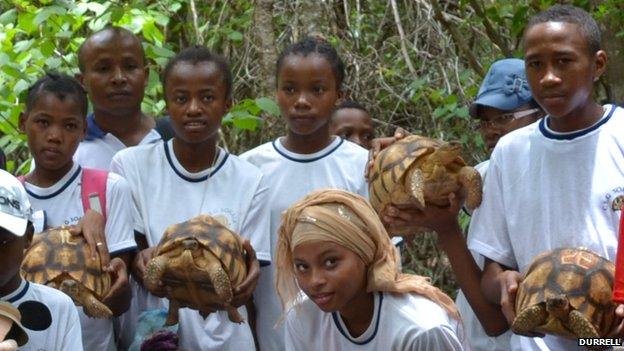 Children in Madagascar with ploughshare tortoises about to be released