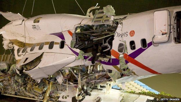 A close up of the upside down plane reveals the damage of the impact and rescue operation