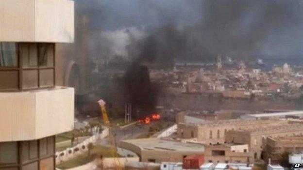 In this file image made from video posted by a Libyan blogger, the Corinthia Hotel is seen under attack in Tripoli, Libya, Tuesday, Jan. 27, 2015.