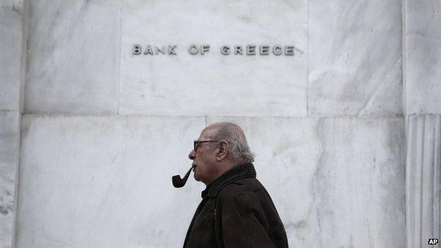 A man walks past the Bank of Greece headquarters, in central Athens, on Wednesday, 4 February 2015