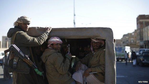 Houthi fighters ride a patrol truck on a street near a gathering for followers of the Houthi movement in Sanaa on 1 February 2015