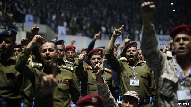Army and police officers loyal to the Houthi movement shout slogans during a gathering in Sanaa on 1 February 2015