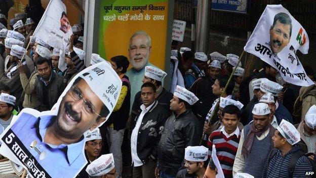 Supporters of Indian political party Aam Admi Party (AAP) party chief Arvind Kejriwal look on during a road show in New Delhi on January 20, 2015