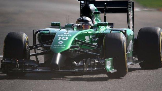 Caterham car of Kamui Kobayashi competing at the Abu Dhabi Grand Prix