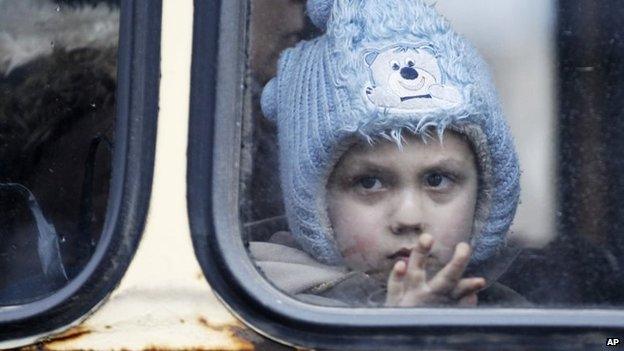 A child waits on a bus to leave the town of Debaltseve, Ukraine, 3 February 2015