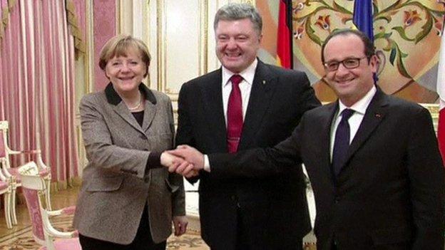 German Chancellor Angela Merkel, Ukrainian President Petro Poroshenko and French President Francois Hollande shaking hands in Kiev, Ukraine, 5 February 2015