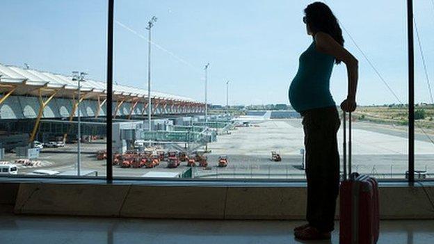 Pregnant woman at the airport