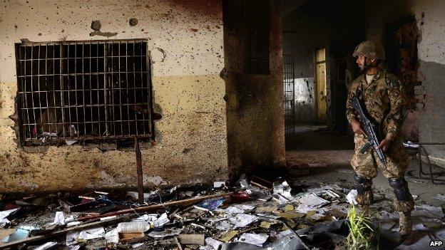 A Pakistani army soldier stands guard at the site of the attack the Peshawar school - 18 December 2014