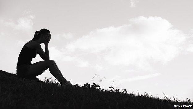 Unhappy teenage girl in silhouette