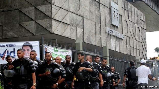 Military Police (PM) walk out after guarding Brazil"s government-run oil company Petrobras during a protest in front of Petrobras headquarters on February 4, 2015