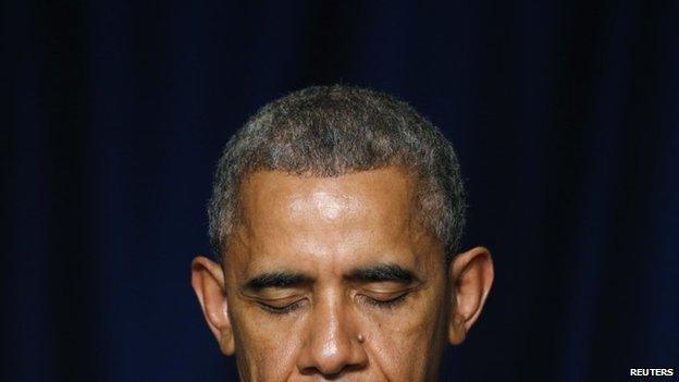 US President Barack Obama bows his head in prayer during the National Prayer Breakfast in Washington, 5 February 2015