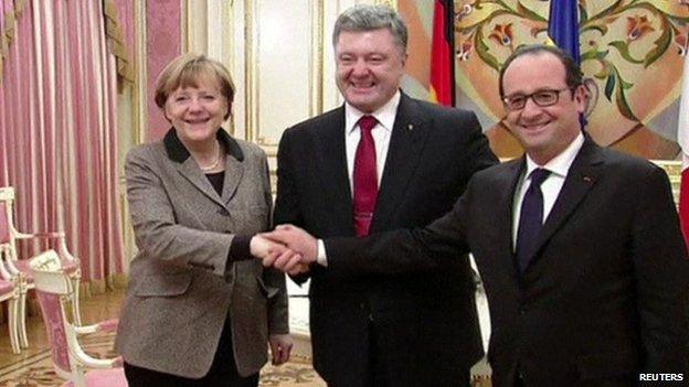 German Chancellor Angela Merkel, Ukrainian President Petro Poroshenko and French President Francois Hollande shaking hands in Kiev, Ukraine, 5 February 2015