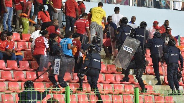 Police try to gain control of fans at the match between Ghana and Equatorial Guinea