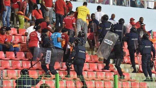 Police try to gain control of fans at the match between Ghana and Equatorial Guinea