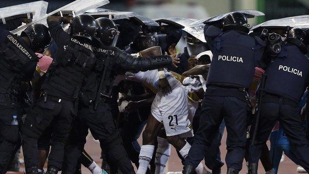 Riot police shield Ghana player