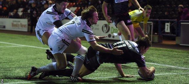 Joel Tomkins goes over for the opening try of the game