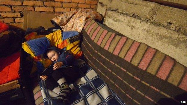 Michal, 4, lies on a makeshift bed as he and others wait for shelling to end in Donetsk's Petrovski district, in the eastern Ukraine on 4 February 2015