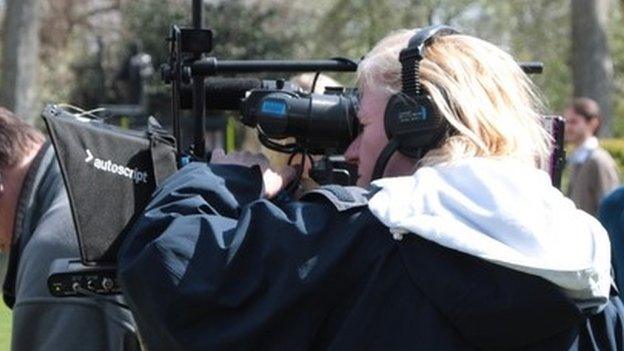 TV camera being operated by a camerawoman