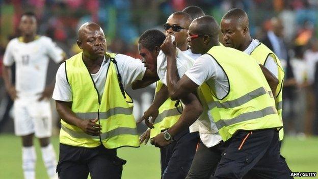 Security drag an Equatorial Guinea fan from the pitch