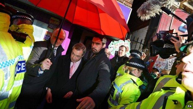 Nigel Farage leaving the building with a police escort