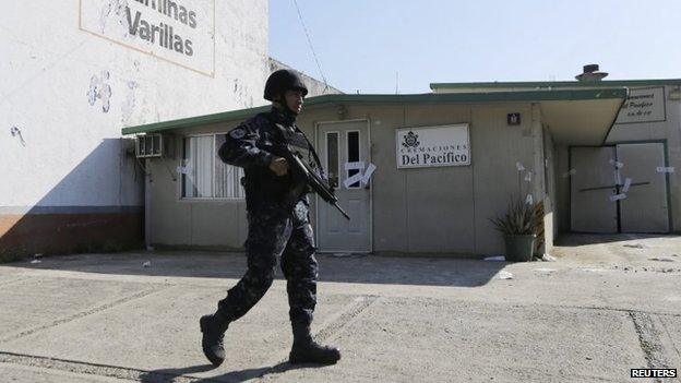 A police officer walks outside the sealed-off building housing a crematorium in Llano Largo, on the outskirts of Acapulco, Mexico.