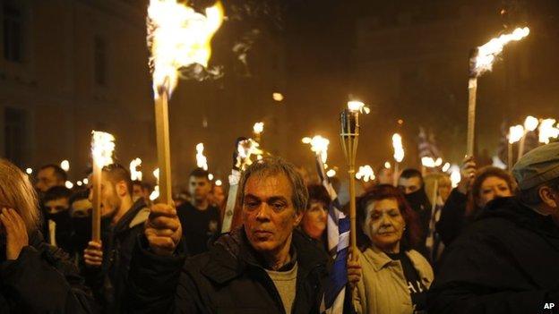 Supporters of Greece's extreme right party Golden Dawn, hold torches during a rally in Greece