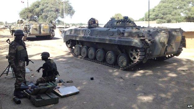 Chadian soldiers patrol near the Cameroonian town of Fotokol, on the border with Nigeria, on 5 February 2015