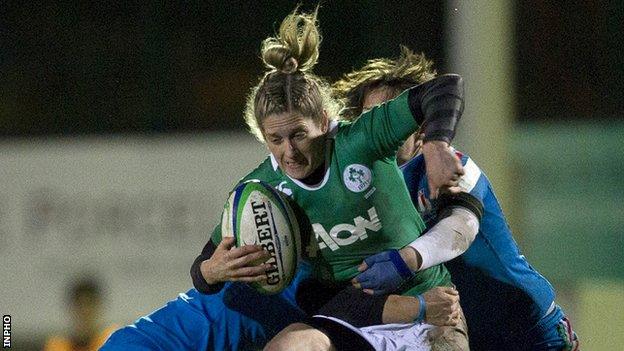 Alison Miller is held up by a couple of Italian tacklers