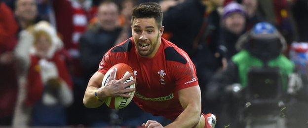 Wales scrum-half Rhys Webb dives over to score