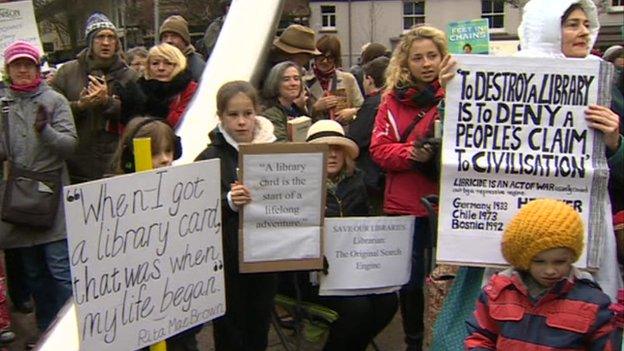 protesters hold banners and placards at the demonstration in Cardiff