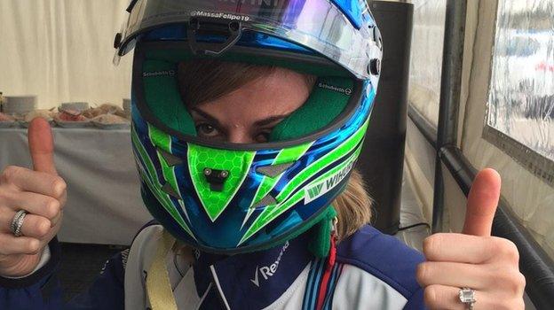 Susie Wolff tries on Felipe Massa's helmet