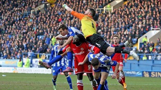 Sheffield Wednesday goalkeeper Keiren Westwood clears from Cardiff goal-scorer Kenwyne Jones