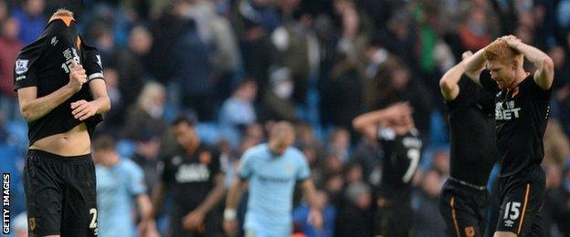 Hull players show their disappointment after conceding a laet goal at Manchester City