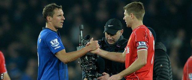 Everton defender Phil Jagielka with Liverpool captain Steven Gerrard