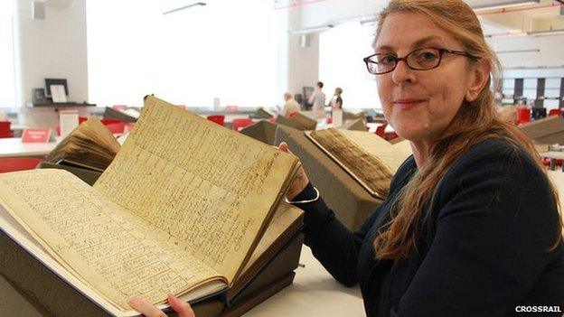 A volunteer searches through parish records