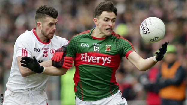 Darren McCurry of Tyrone challenges Mayo's Jason Doherty