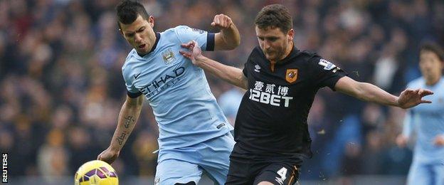 Hull City defender Alex Bruce (right) in action against Manchester City