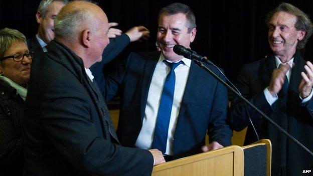 Frederic Barbier (C), socialist"s party (PS) candidate, smiles at the end of the second round of the by-election in the 4th constituency in the French Doubs region on February 8, 2015, in Audincourt