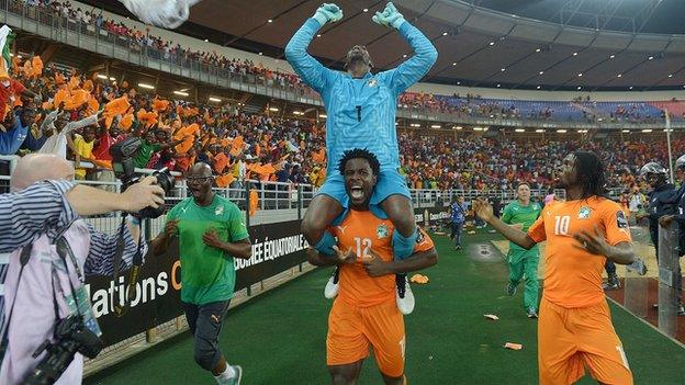 Wilfried Bony carries goalkeeper Boubacar Barry on his shoulders after Ivory Coast beat Ghana to win the Africa Cup of Narions